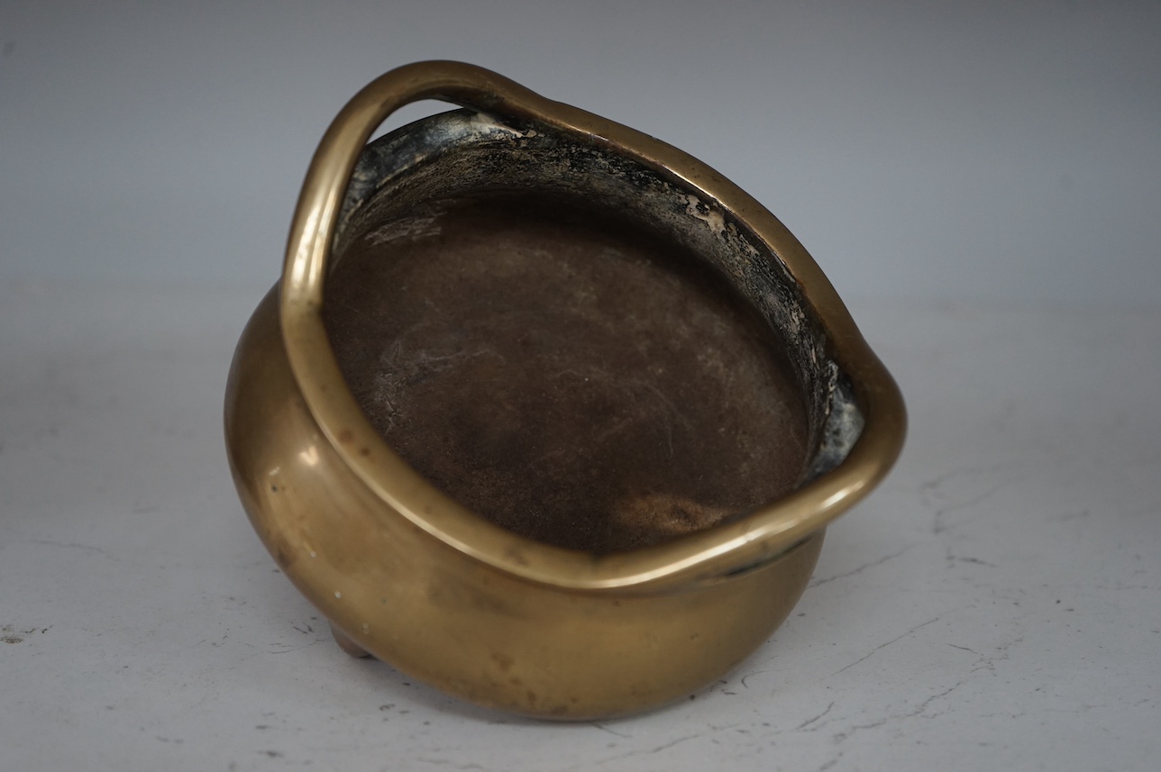 A Chinese bronze tripod censer, archaic Xuande seal mark, 19th century, 11cm. Condition - good